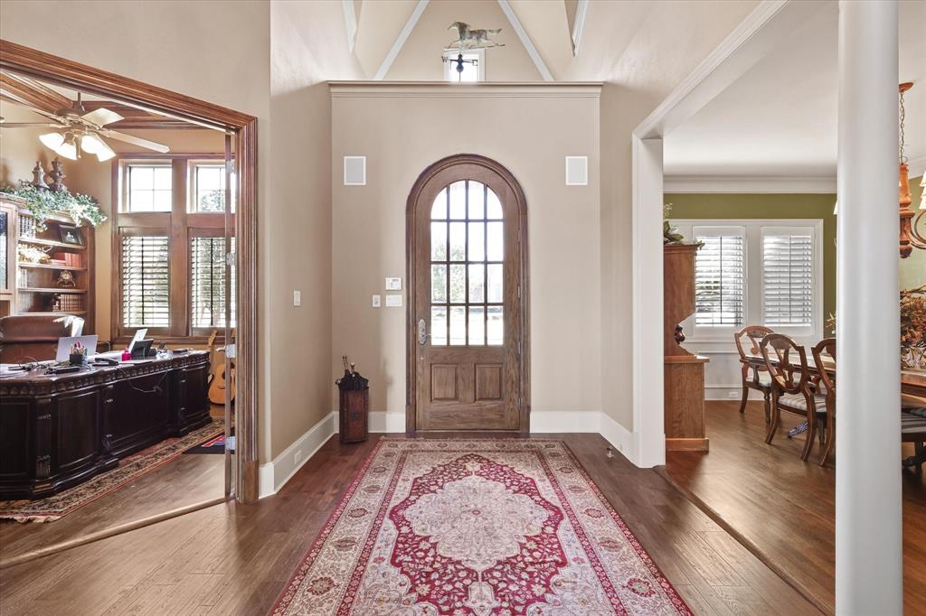 2021 Kings Pass Heath, TX 75032 - Photo 4 of 37 a view of a hallway with wooden floor and furniture