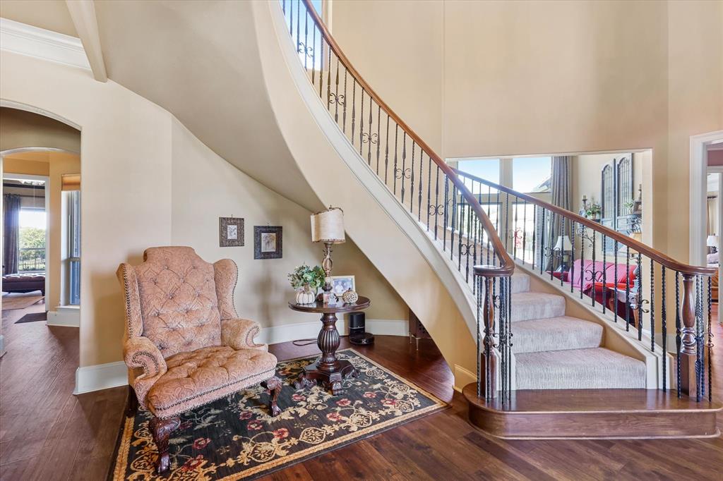 2021 Kings Pass Heath, TX 75032 - Photo 6 of 37 a living room with wooden floor and stairs