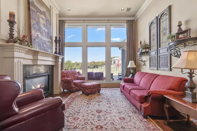 a living room with furniture fireplace and a large window