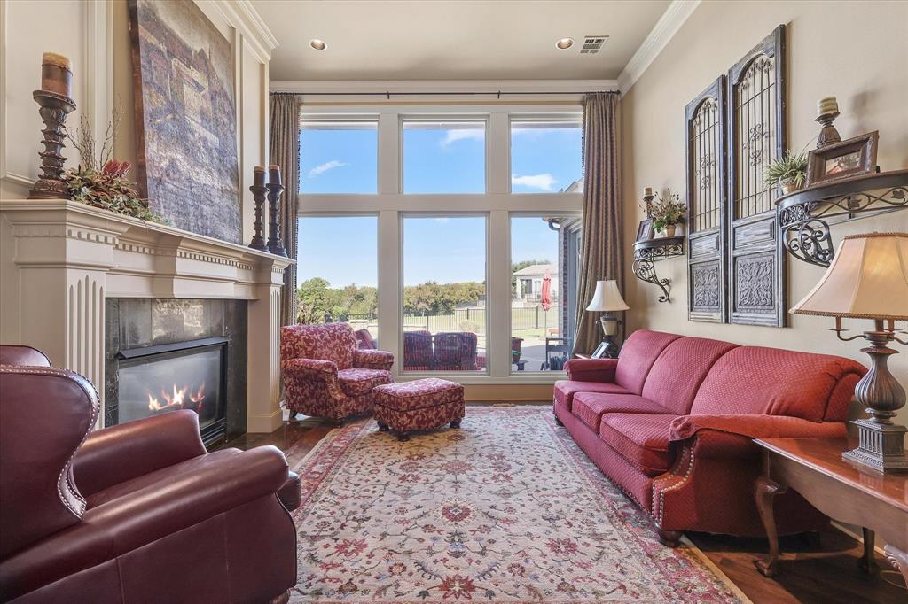 2021 Kings Pass Heath, TX 75032 - Photo 9 of 37 a living room with furniture fireplace and a large window