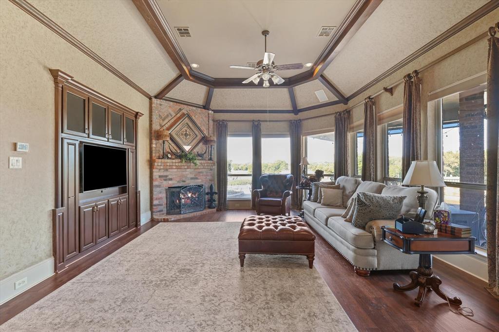 2021 Kings Pass Heath, TX 75032 - Photo 10 of 37 a living room with furniture a flat screen tv and a floor to ceiling window