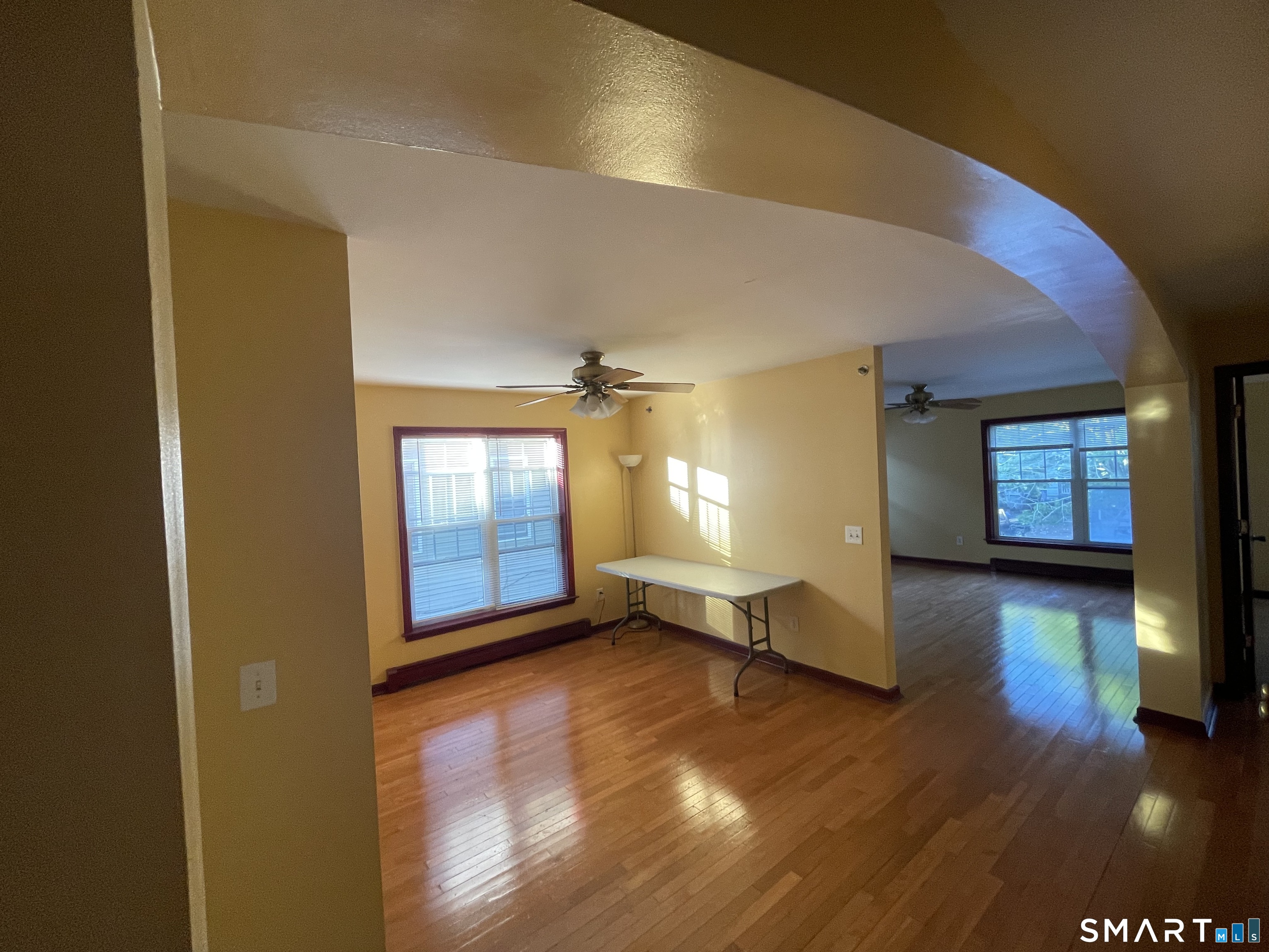 11 Button Street New Haven, CT 06519 - Photo 15 of 18 an empty room with wooden floor and windows