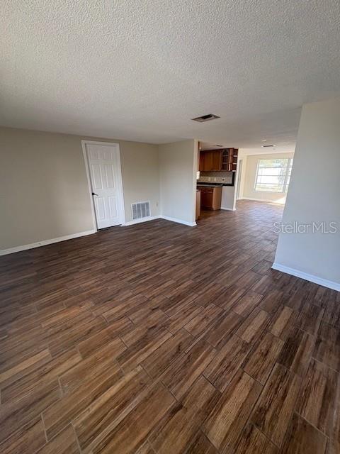 7839 Canna Drive Port Richey, FL 34668 - Photo 3 of 12 a view of empty room with wooden floor