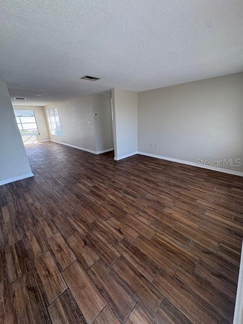 7839 Canna Drive Port Richey, FL 34668 - Photo 6 of 12 a view of empty room with wooden floor