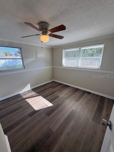 7839 Canna Drive Port Richey, FL 34668 - Photo 8 of 12 a view of an empty room with wooden floor and window