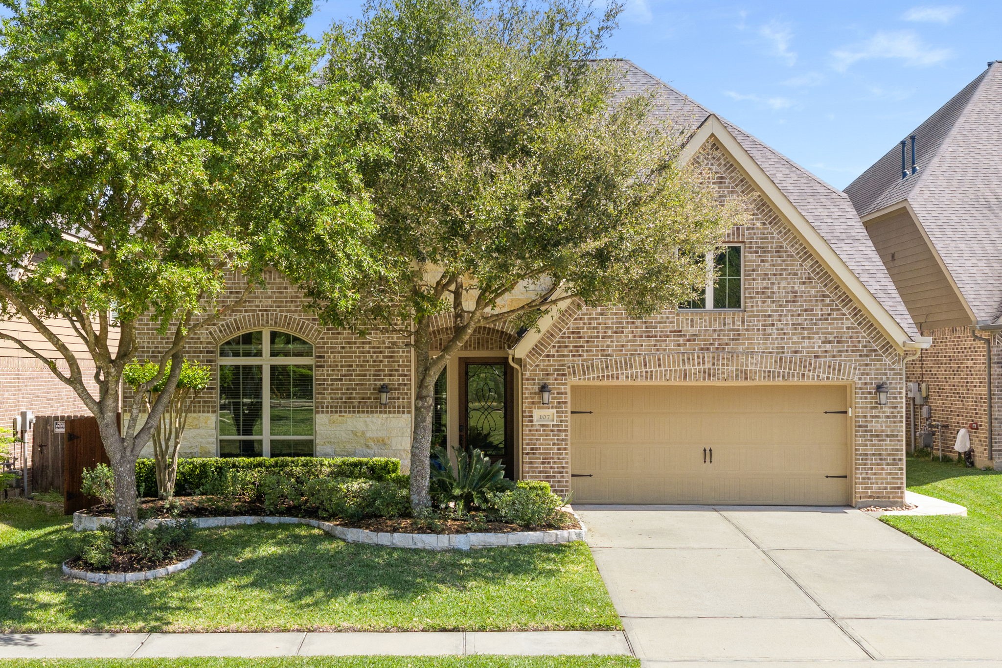 107 Elk Run Court Conroe, TX 77384 - Photo 1 of 50 This charming home features a classic brick exterior with a gabled roof.