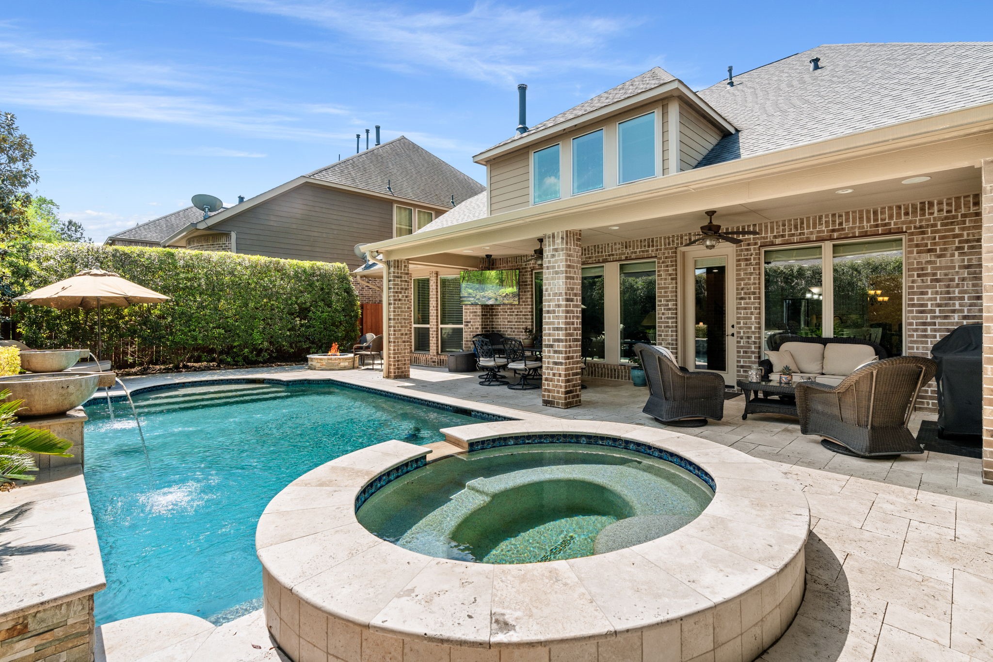 107 Elk Run Court Conroe, TX 77384 - Photo 3 of 50 Beautiful backyard with a sparkling pool and attached hot tub, surrounded by a spacious patio.