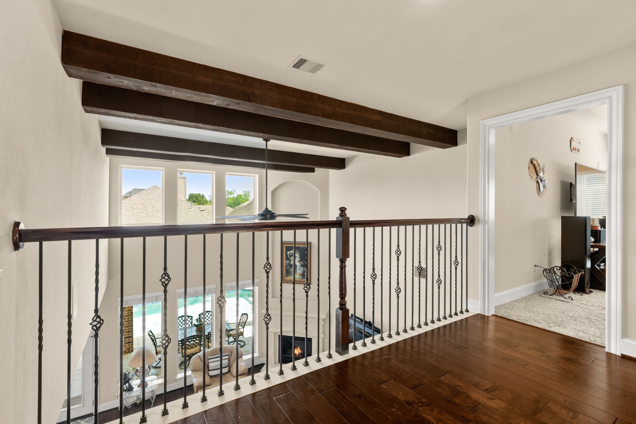 107 Elk Run Court Conroe, TX 77384 - Photo 32 of 50 Banister view overlooking living room and outdoor pool