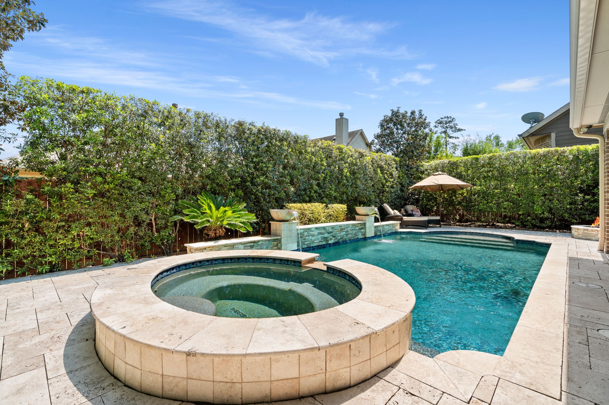 107 Elk Run Court Conroe, TX 77384 - Photo 4 of 50 Lush greenery and privacy hedges add a serene touch.