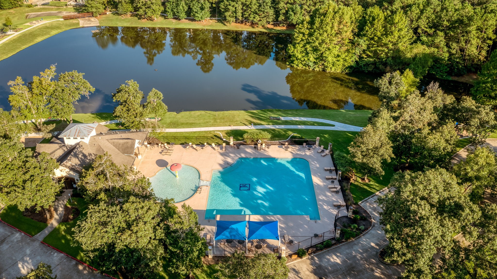 107 Elk Run Court Conroe, TX 77384 - Photo 49 of 50 Community pool, walking trails, and stocked lake