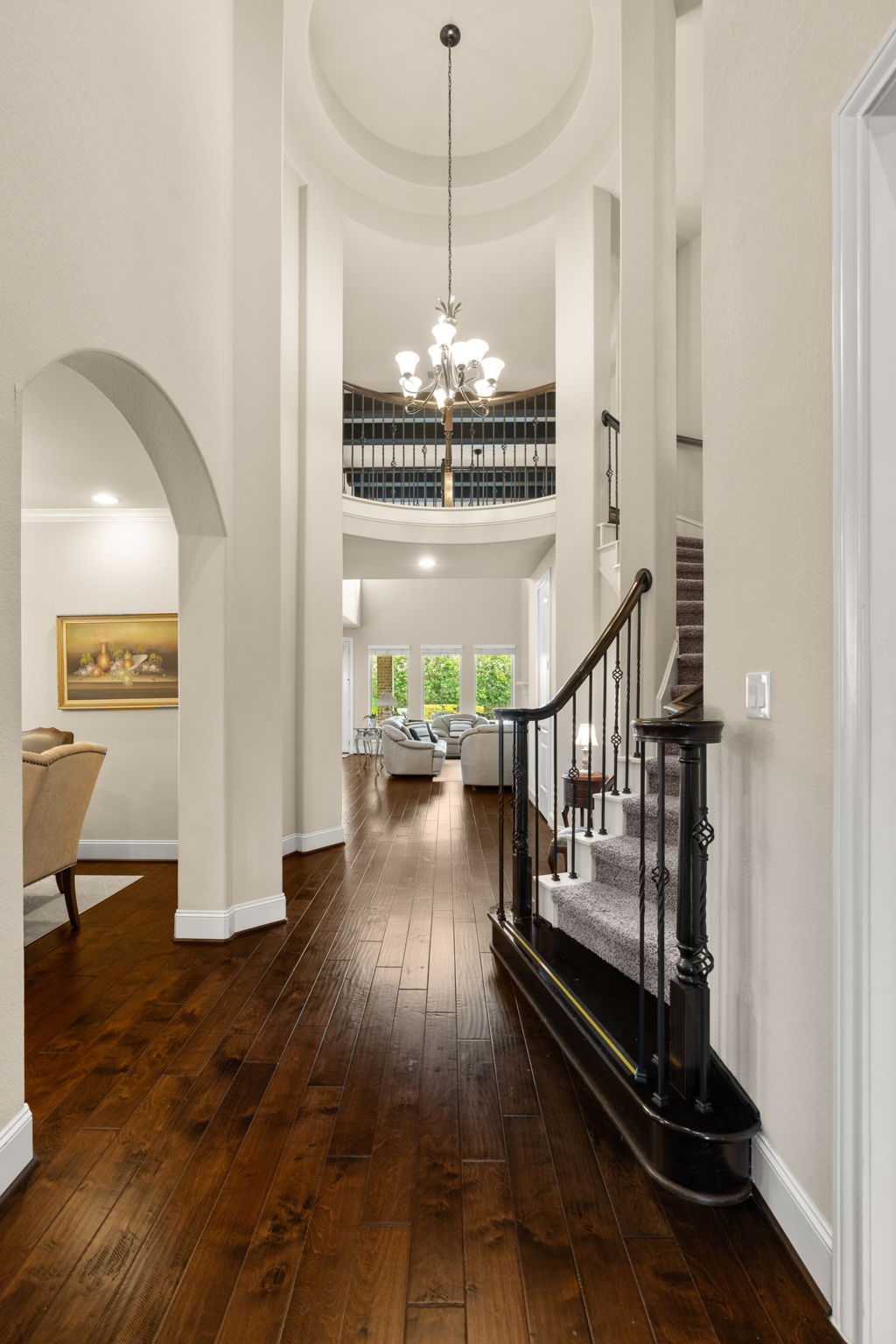 107 Elk Run Court Conroe, TX 77384 - Photo 9 of 50 Stunning living room featuring a beautiful wood-beamed ceiling, creating an inviting and elegant atmosphere.
