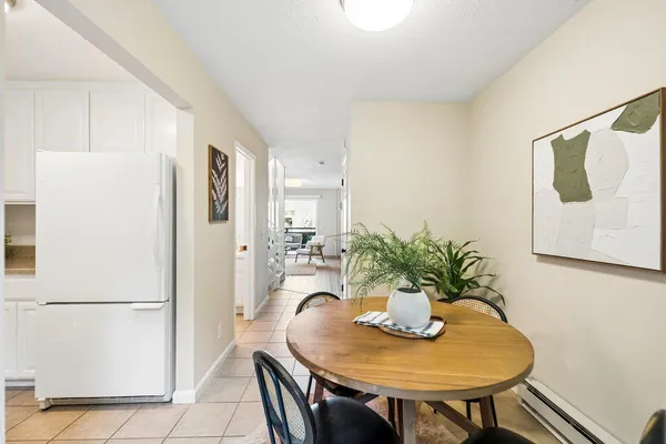 a view of a dining room with furniture and a potted plant