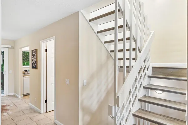 a view of staircase with white walls and windows