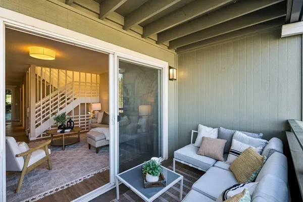 a view of a living room and a balcony
