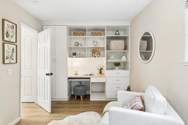 a living room with furniture and a painting