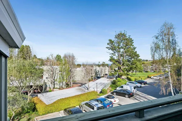 a view of a swimming pool with a patio and a yard