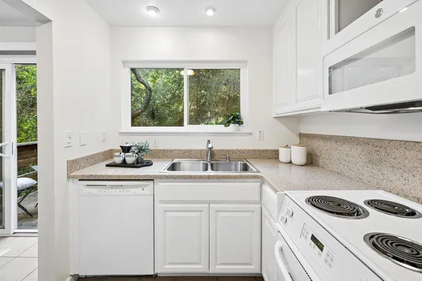 a kitchen with a sink stove and cabinets