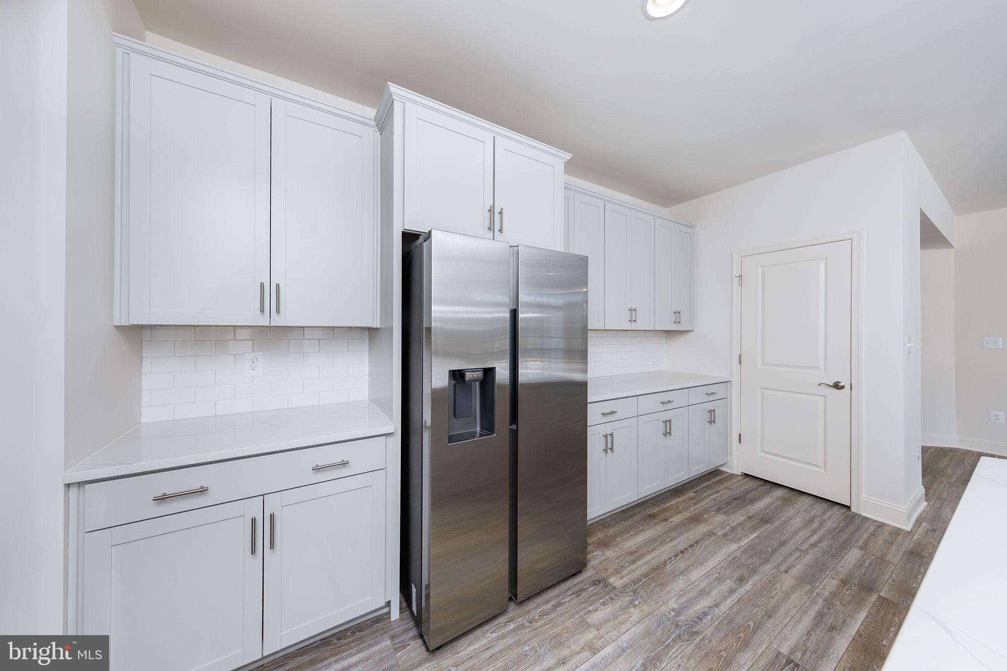 15719 Henrietta Drive Accokeek, MD 20607 - Photo 28 of 48 a kitchen with stainless steel appliances a refrigerator and cabinets