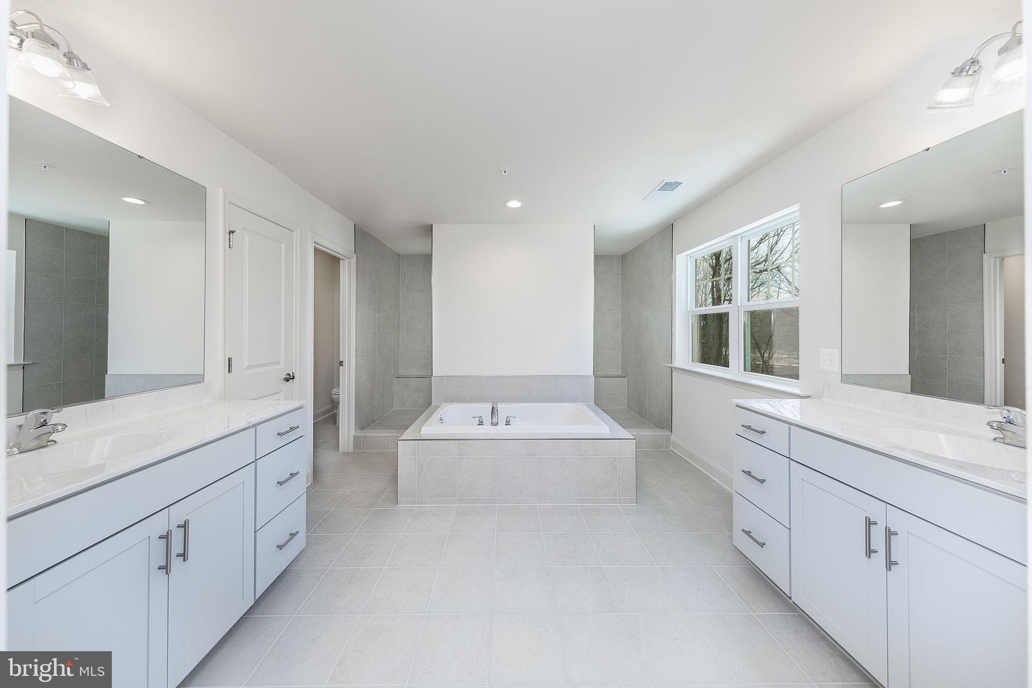 15719 Henrietta Drive Accokeek, MD 20607 - Photo 43 of 48 a spacious bathroom with a double vanity sink mirror double and bathtub