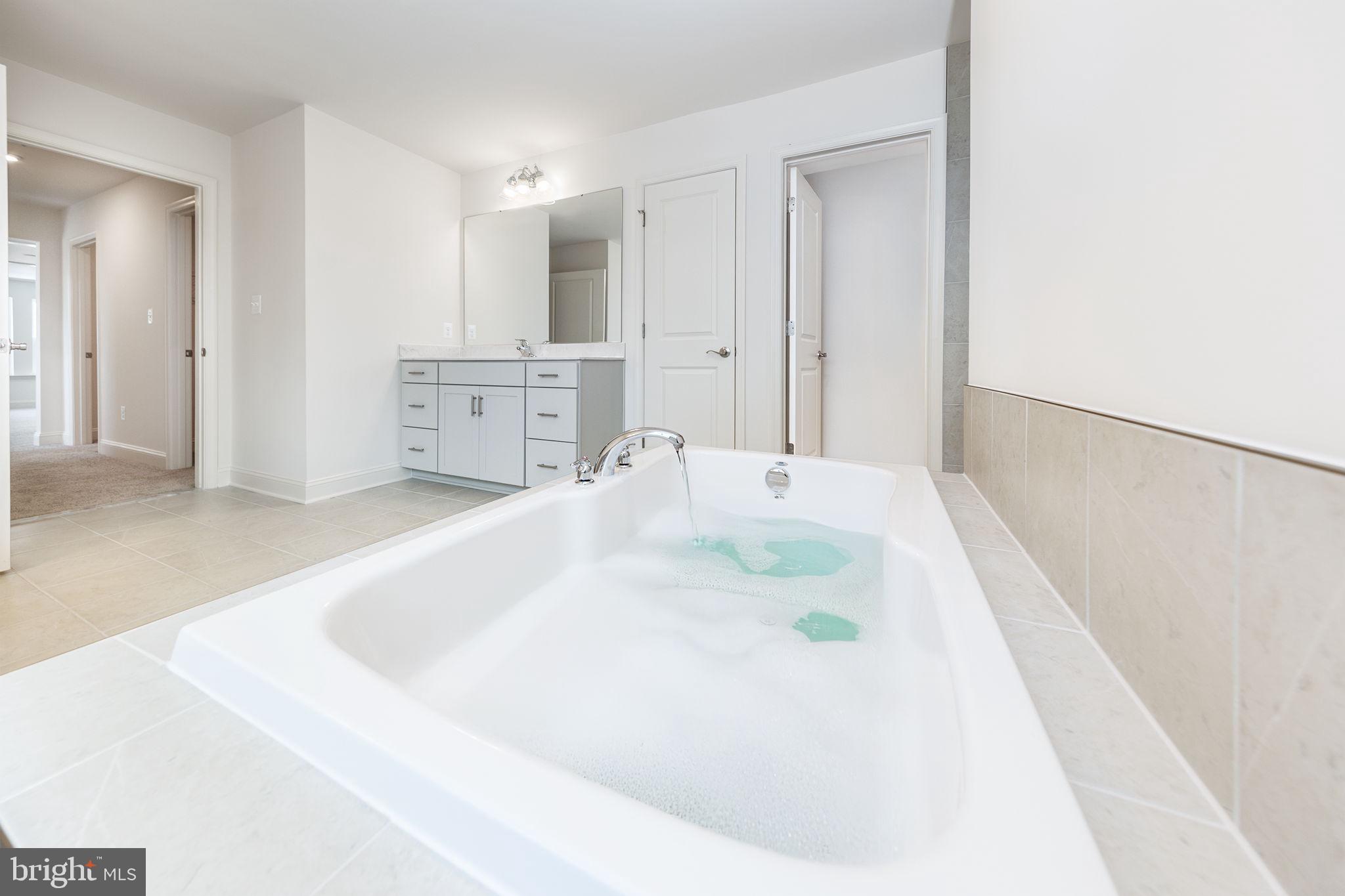 15719 Henrietta Drive Accokeek, MD 20607 - Photo 44 of 48 a bathroom with a white tub