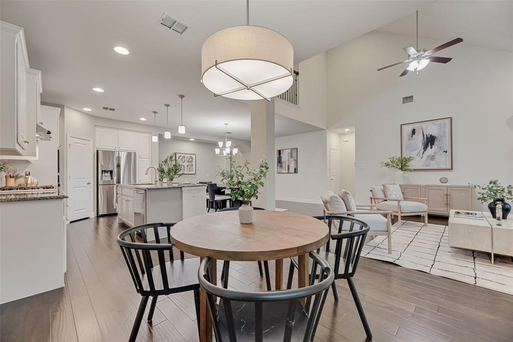 1508 Cherry Blossom Lane Prosper, TX 75078 - Photo 13 of 40 a view of a dining room with furniture and wooden floor