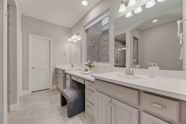 a spacious bathroom with a sink and a mirror