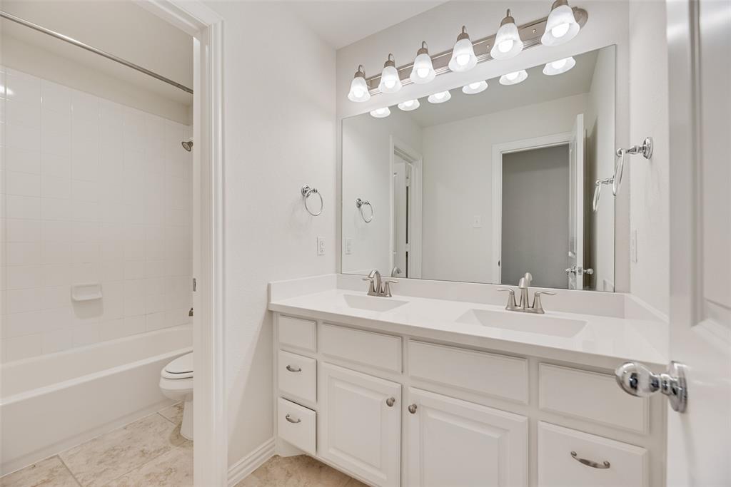 1508 Cherry Blossom Lane Prosper, TX 75078 - Photo 26 of 40 a bathroom with a tub a sink and mirror