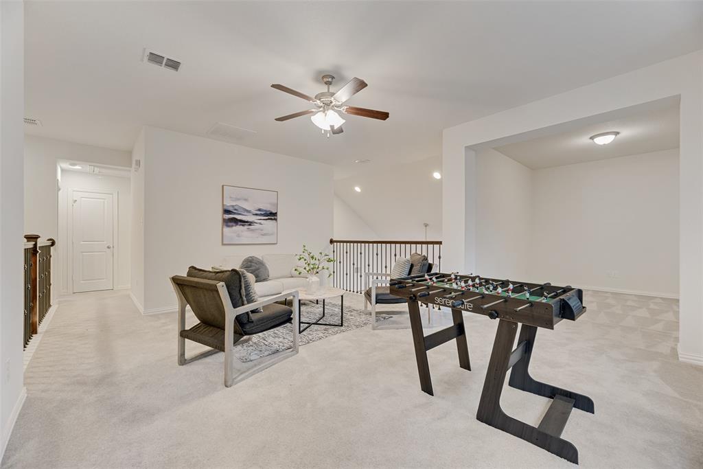 1508 Cherry Blossom Lane Prosper, TX 75078 - Photo 30 of 40 a view of a livingroom with furniture and a ceiling fan