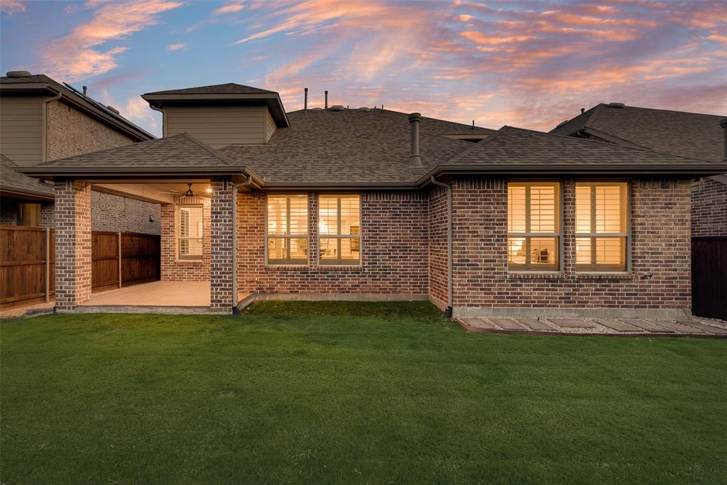 1508 Cherry Blossom Lane Prosper, TX 75078 - Photo 38 of 40 a front view of a house with a garden