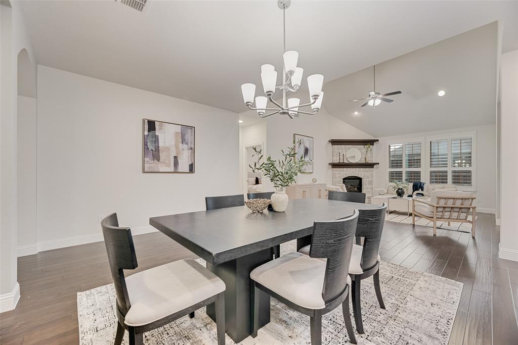 1508 Cherry Blossom Lane Prosper, TX 75078 - Photo 4 of 40 a view of a dining room with furniture a chandelier and wooden floor