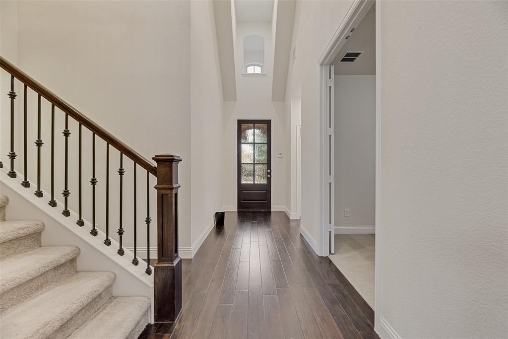 1508 Cherry Blossom Lane Prosper, TX 75078 - Photo 5 of 40 a view of a hallway with wooden floor and staircase