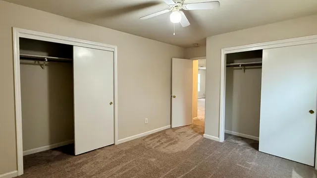 an empty room with closet and a hallway