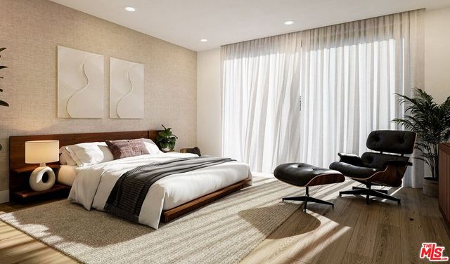 a bed room with a bed and a chair