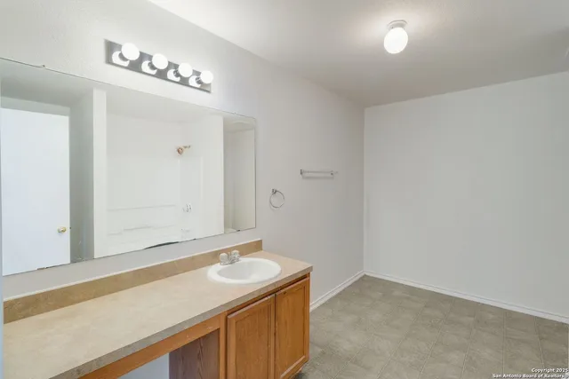 a bathroom with a sink and a mirror