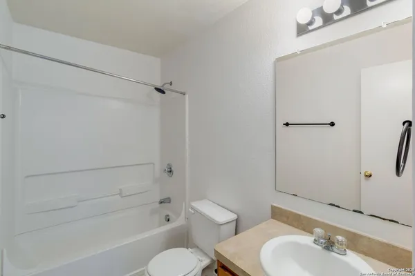a bathroom with a toilet and a bathtub