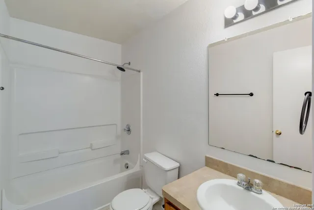 a bathroom with a toilet and a bathtub