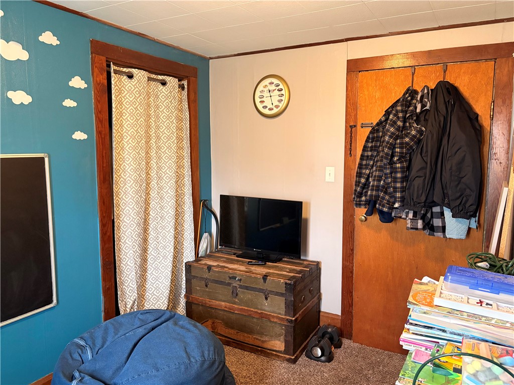 321 Liberty Street Eaton, OH 45320 - Photo 27 of 34 This cozy bedroom features warm wooden trim and soft carpeting, creating a comfortable living space.