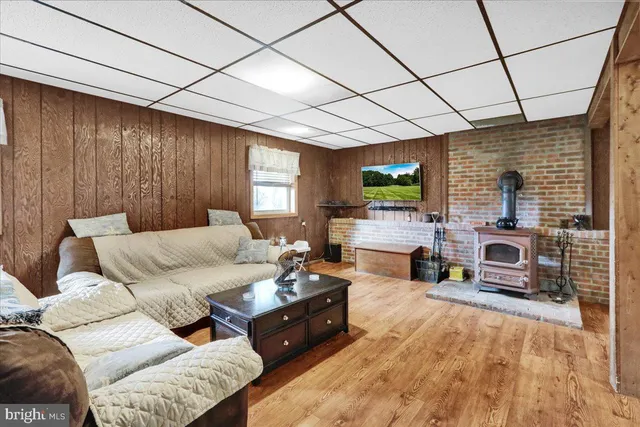 a living room with furniture flat screen tv and a fireplace
