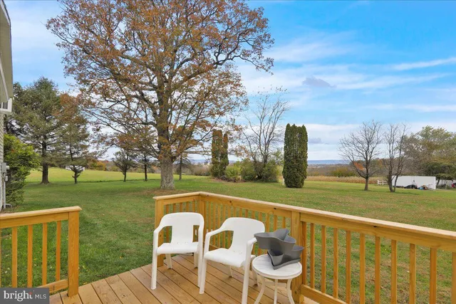 a view of a lake with a table and chairs