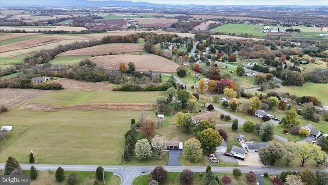 an aerial view of ocean and residential houses with outdoor space