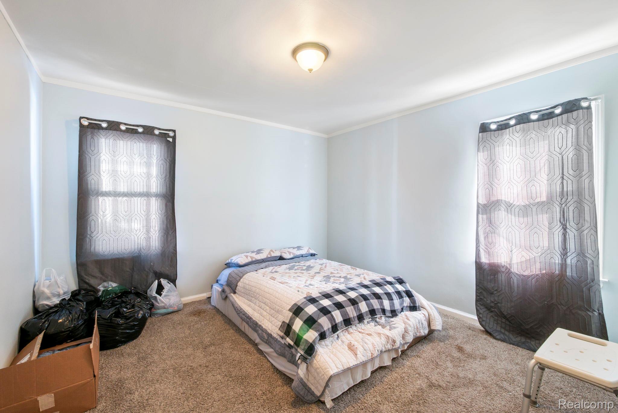 7739 Rosedale Boulevard Allen Park, MI 48101 - Photo 16 of 28 Carpeted bedroom featuring ornamental molding and baseboards