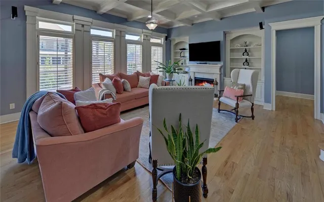 a living room with lots of books and a book shelf