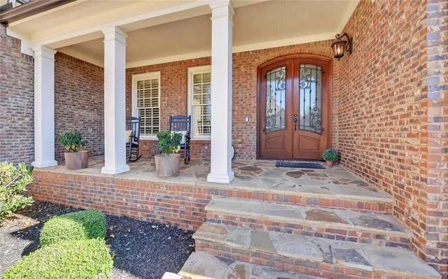 a view of a patio with chairs and potted plants