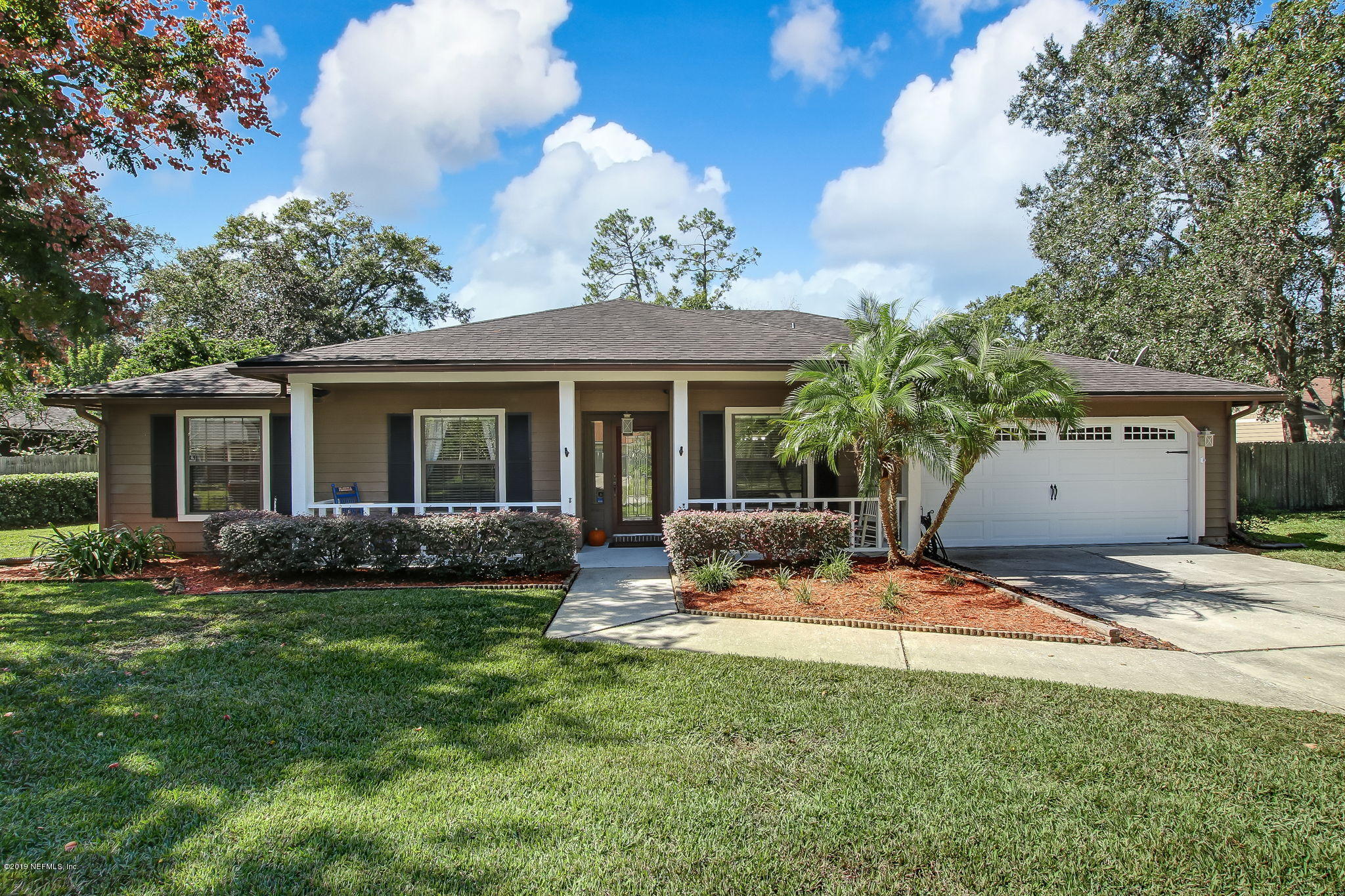 11060 Reading Road Jacksonville, FL 32257 - Photo 1 of 43 a view of a backyard with table and chairs and floor to ceiling window