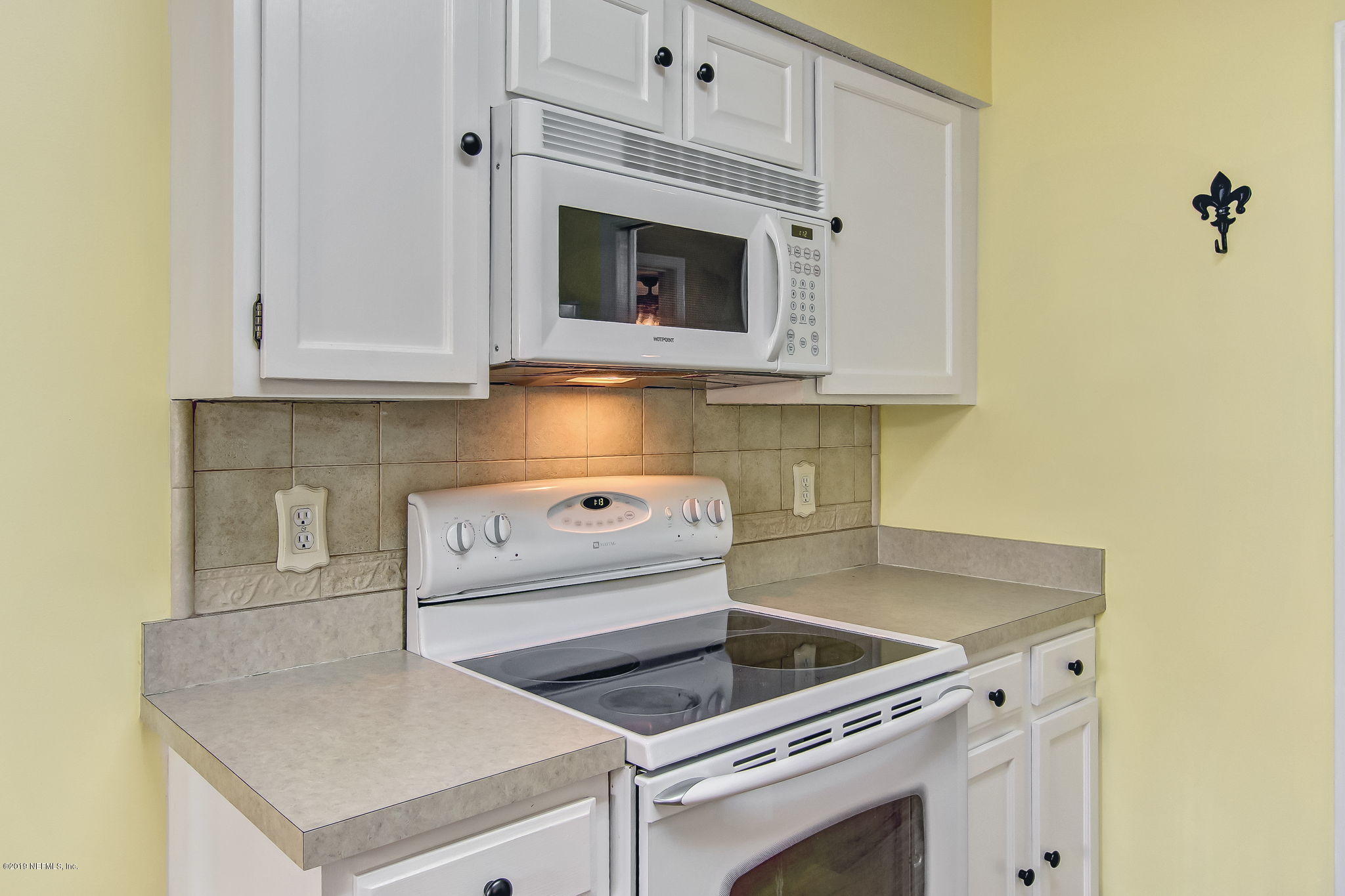 11060 Reading Road Jacksonville, FL 32257 - Photo 16 of 43 a kitchen with granite countertop white cabinets and white appliances