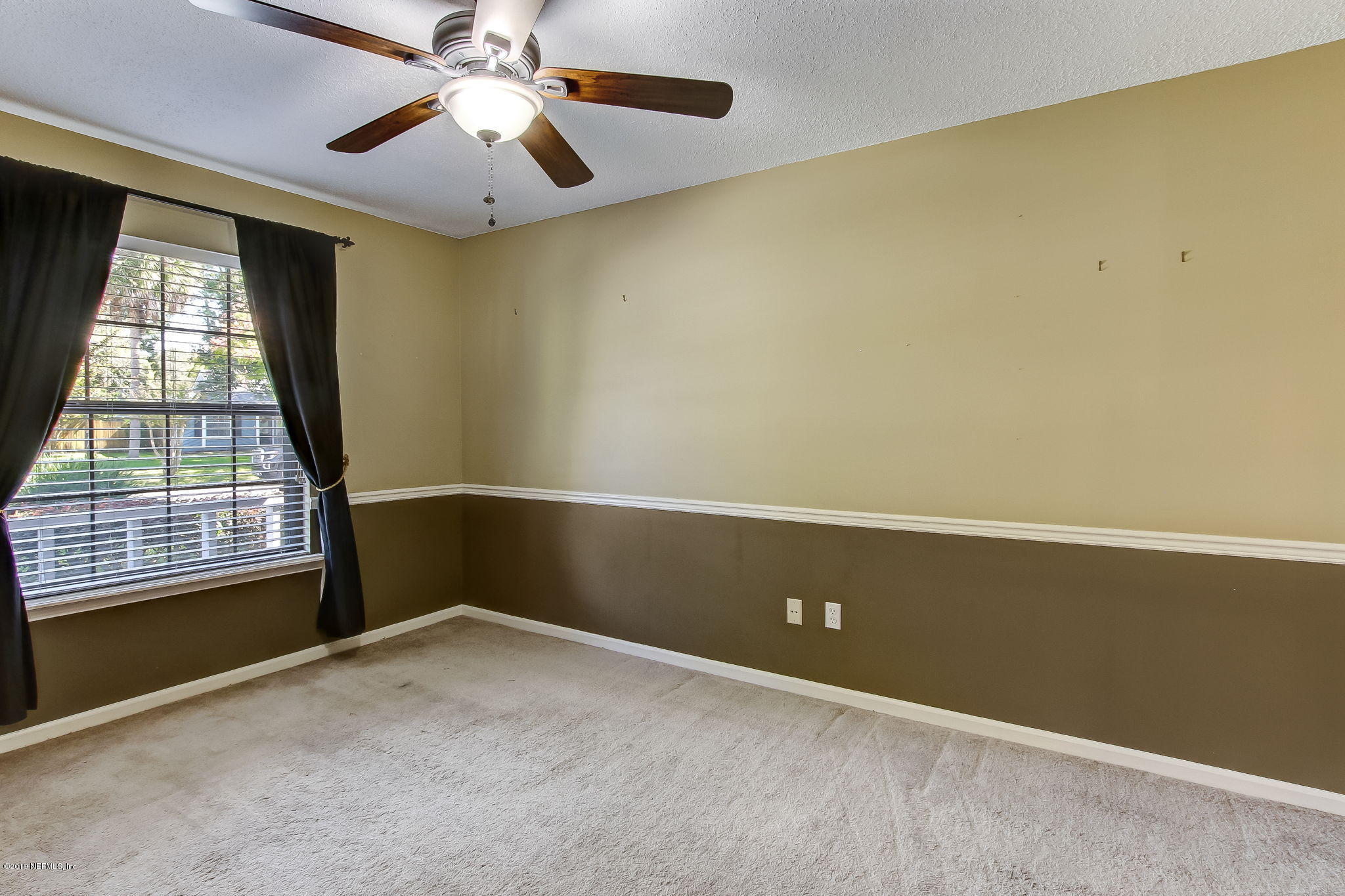 11060 Reading Road Jacksonville, FL 32257 - Photo 20 of 43 an empty room with windows and fan
