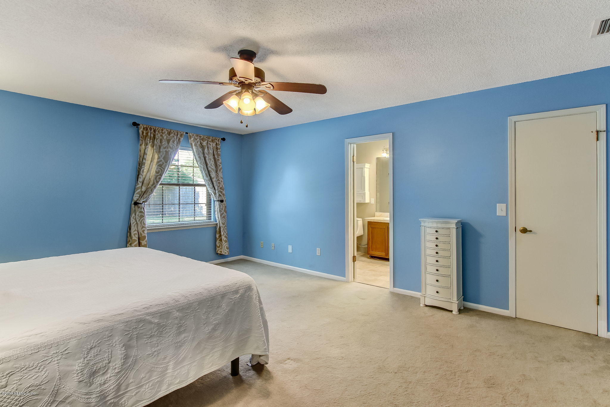 11060 Reading Road Jacksonville, FL 32257 - Photo 22 of 43 a bedroom with a bed and a chandelier