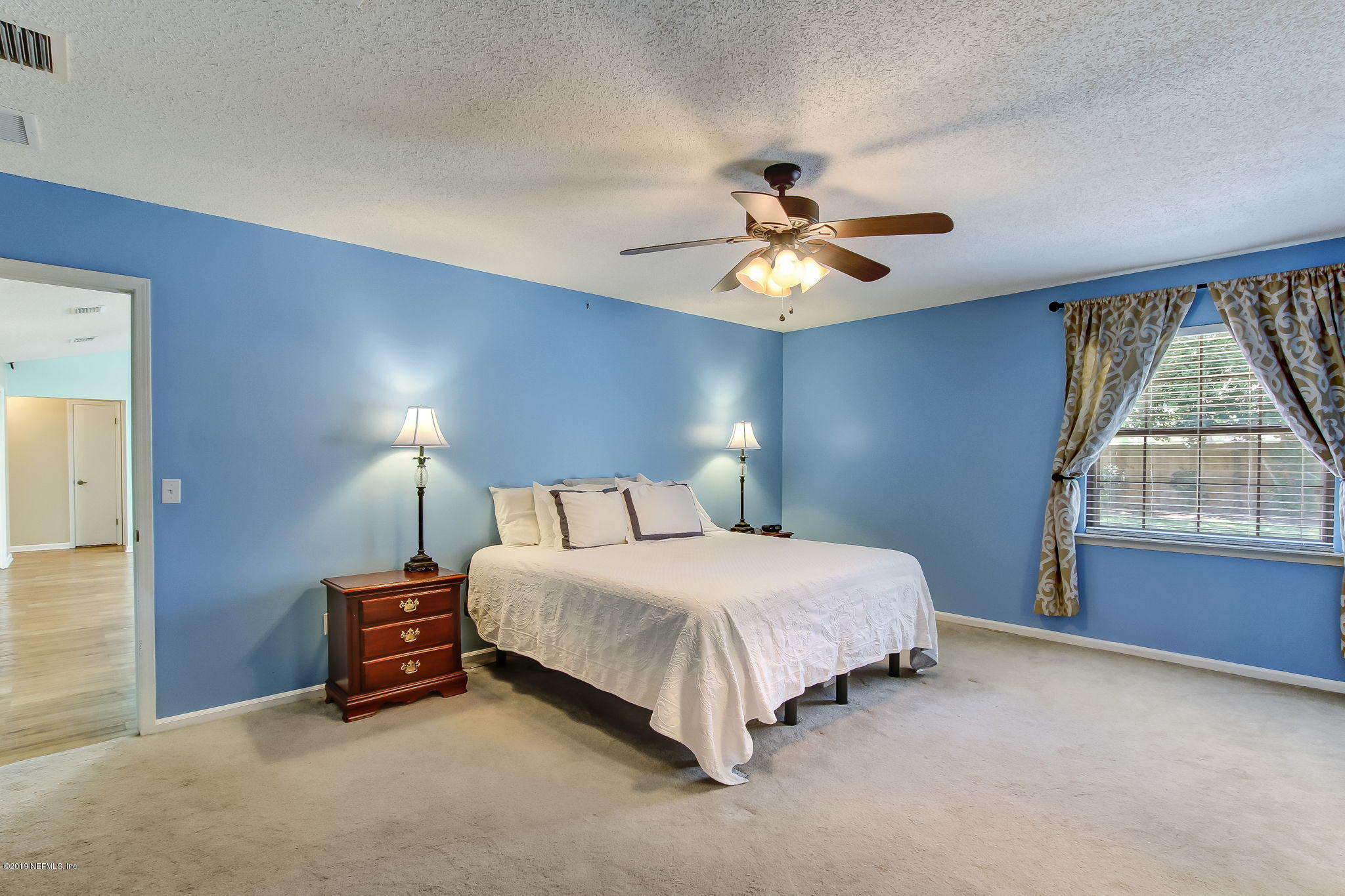 11060 Reading Road Jacksonville, FL 32257 - Photo 23 of 43 a bedroom with a bed chandelier and a window