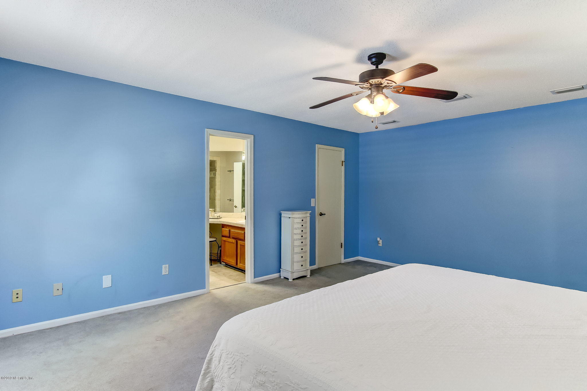 11060 Reading Road Jacksonville, FL 32257 - Photo 24 of 43 a bedroom with a bed and a chandelier