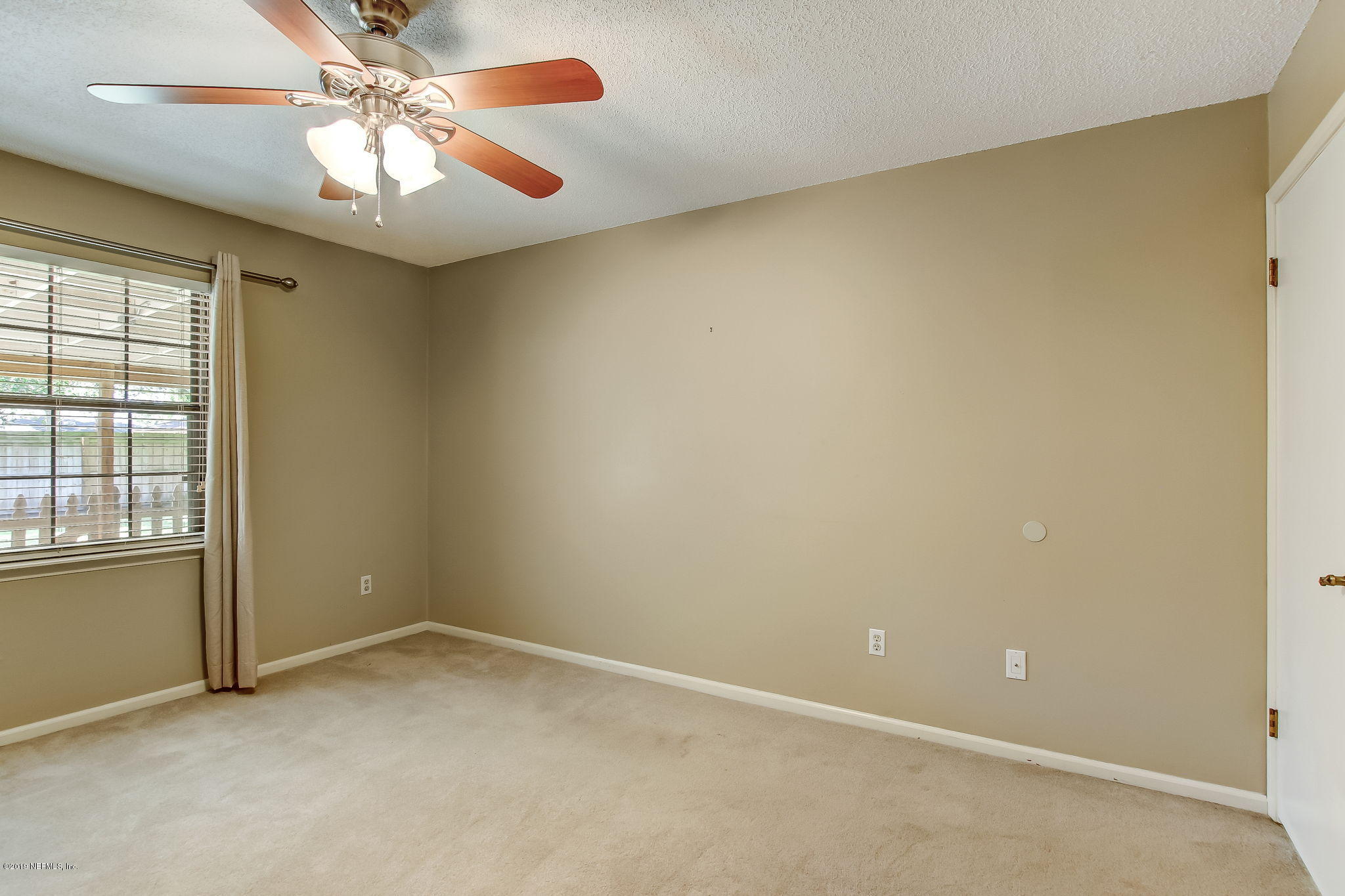 11060 Reading Road Jacksonville, FL 32257 - Photo 27 of 43 an empty room with windows and fan